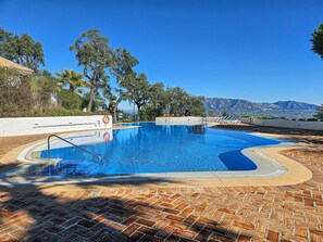 A swimming pool with a clear view of mountains in the background.
