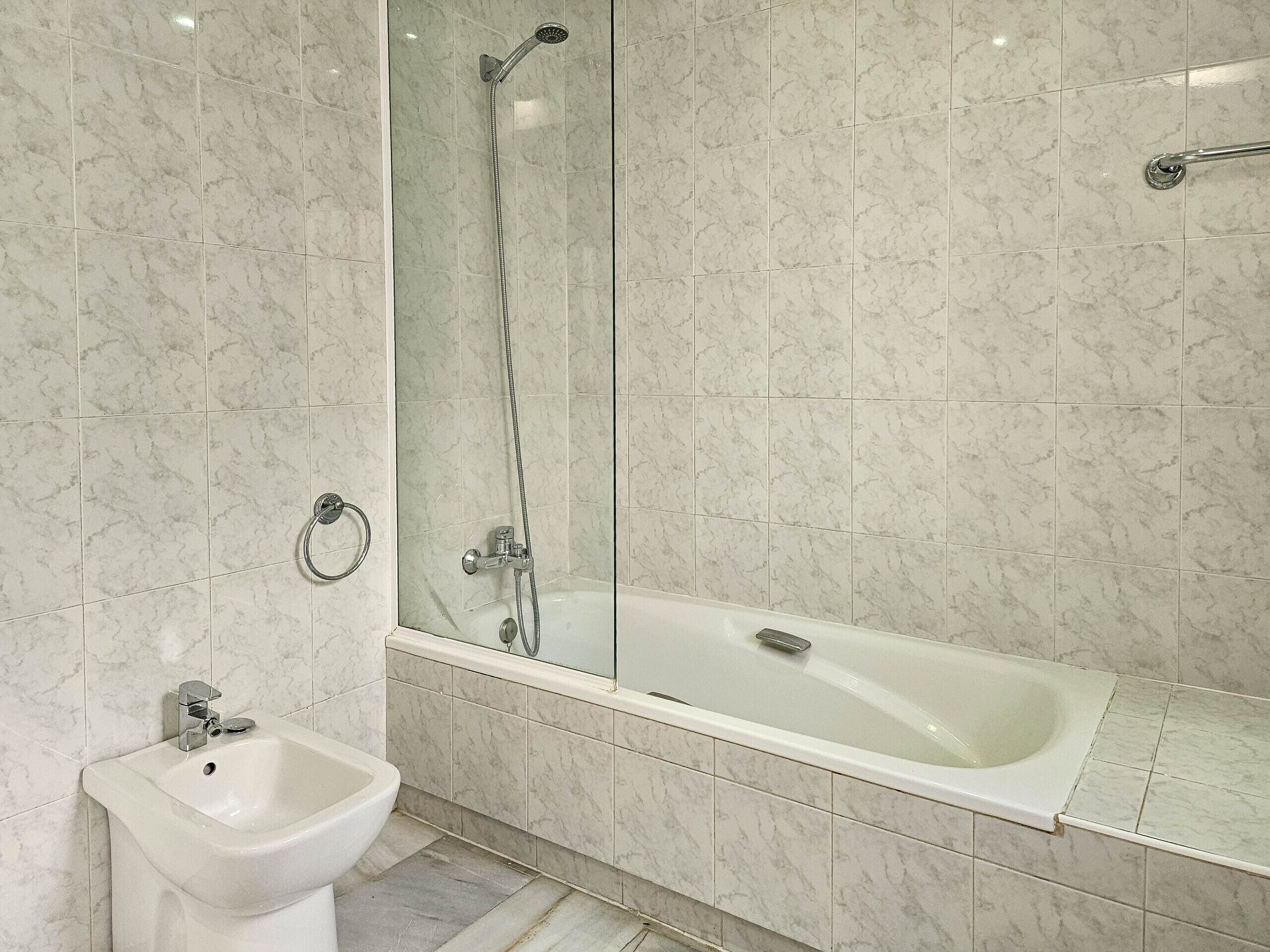 A modern bathroom with a bathtub, a shower, and a bidet.