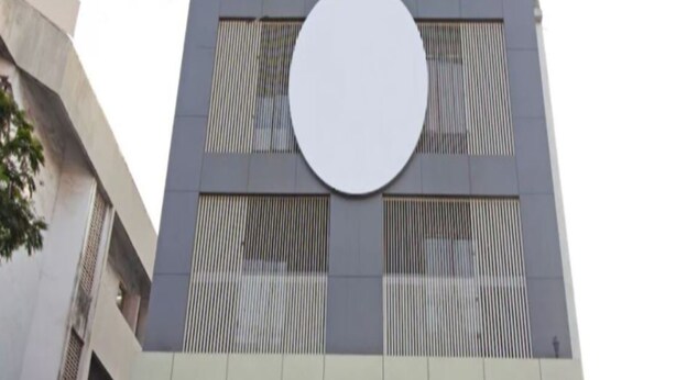 A modern building with a large circular window and a flat roof. - Panvel Palace (Panvel)