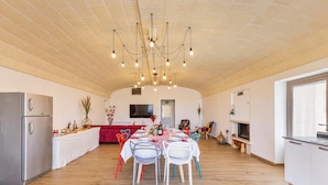 A spacious kitchen with a dining area, wooden flooring, and a modern chandelier. - 2943 Casa Marangi by Barbarhouse (Ostuni)