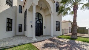 A building with a white facade, black-framed windows, and a black entrance door. - Lagoon Suites Boutique Hotel (Walvis Bay)