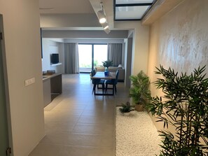 Un espace de vie moderne comprenant une table à manger, des chaises, un canapé et un téléviseur.