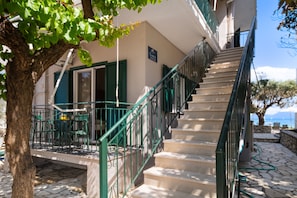 A staircase leading to a building with a sign reading 'SIMOS HOUSE.'