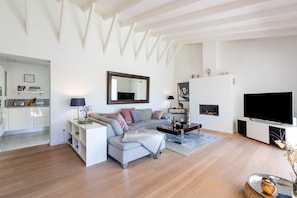 A modern living room with a sofa, coffee table, and TV.