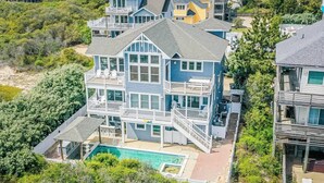 A multi-story beachfront property with a pool and multiple balconies. - Make Lasting Memories at 'Memory Maker' | Pool, Hot Tub, Game Room | Perfect for Large Families (Corolla)