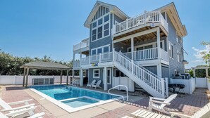 A two-story house with a pool, outdoor seating, and a covered patio area. - Make Lasting Memories at 'Memory Maker' | Pool, Hot Tub, Game Room | Perfect for Large Families (Corolla)