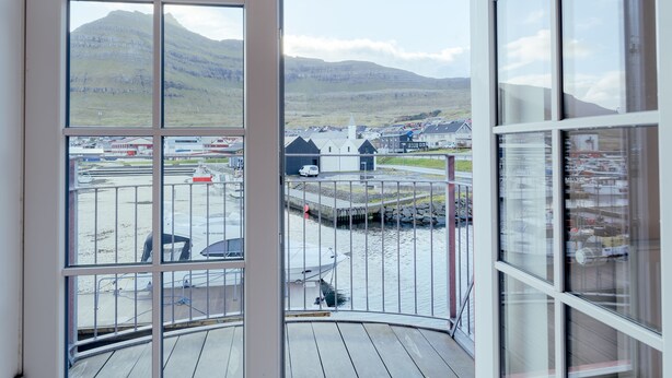 A view from a balcony with a clear sky and distant mountains. - New Boat Houses (Leirvik)