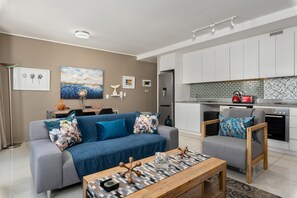 Comfort Apartment | Living area | 55-inch TV with cable channels, Netflix, streaming services
