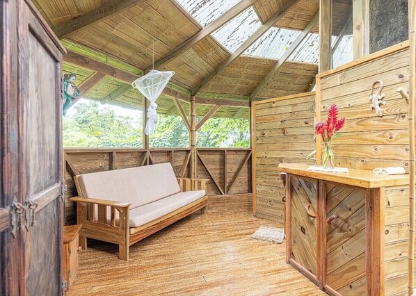 Relax in a cozy space with a sloped ceiling, cushioned bench, and natural materials.