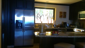 A modern kitchen with a stainless steel refrigerator, a coffee maker, and a fruit bowl on the counter. - Beautiful, Luxurious Puerto Vallarta Resort (Puerto Vallarta, Jalisco)