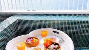 A breakfast setup on a balcony with a view of the sea, including croissants, fruit, and a glass of orange juice. - House with Ocean view good for 8PPL Free WiFi (Suooshima, Oshima District)