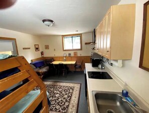 Cozy room with a kitchenette, dining area, and comfortable seating.