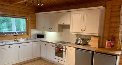 Log cabin with veranda, nestled in Kenwick Park, Louth