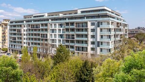 A multi-story hotel with a modern architectural design, featuring balconies on each floor and a flat roof. - WestSide Apartments by FirstHost (Budapest)
