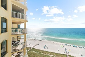 A beachfront hotel with multiple balconies, a sandy beach, and ocean views. - Beach Colony Tower 13D - Indoor Pool - HASSLE-FREE CHECK OUT (Perdido Key)