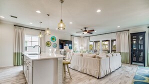A spacious kitchen with a central island, pendant lighting, and a ceiling fan. - Lost Key Villas Golf & Beach Club ~CS'ta on the Key -  NO HASSLE CHECK OUT (Pensacola)