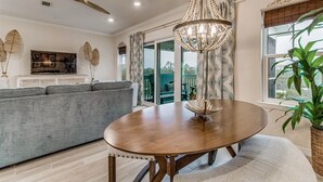 A dining area with a round wooden table, a chandelier, and a ceiling fan. - Lost Key Townhomes 14274 ~ Flip Flop Stop  -  NO HASSLE CHECK OUT (Pensacola)