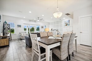 A spacious kitchen with a dining area, featuring a chandelier, white cabinetry, and a view of the outdoors. - NEW LISTING! Lost Key Golf & Beach Club ~ Pelicans Paradise - NO HASSLE CHECK OU (Perdido Key)