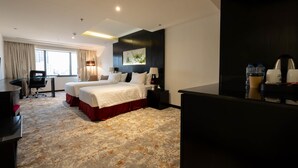 A hotel room with a large bed, two bedside tables, a desk, and a chair. - MIRA BUSINESS HOTEL (Riyadh)