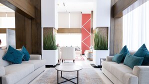 A modern living room with two sofas, a coffee table, and decorative plants. - MIRA BUSINESS HOTEL (Riyadh)