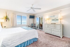 A bedroom with a bed, a dresser, a ceiling fan, a window with blinds, a plant, and a view of the outdoors. - Sandy Key 233 Second floor -Beachfront view -NO HASSLE CHECK OUT (Perdido Key)