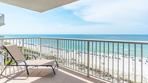 A balcony with a view of a beach and ocean. - Sandy Key 735 -7th floor -Beachfront view -NO HASSLE CHECK OUT (Pensacola)