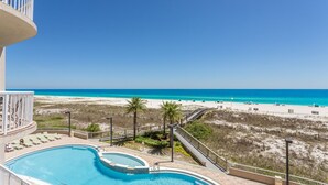 A pool with a view of a beach and ocean. - Spanish Key 207  Beachfront view  - NO HASSLE CHECK OUT (Perdido Key)
