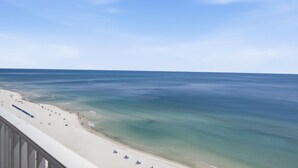 A beach with a clear view of the ocean and a sandy shoreline.