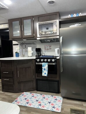 Fridge, microwave, stovetop, coffee/tea maker