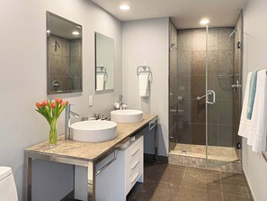 Bathtub, hair dryer, towels, shampoo