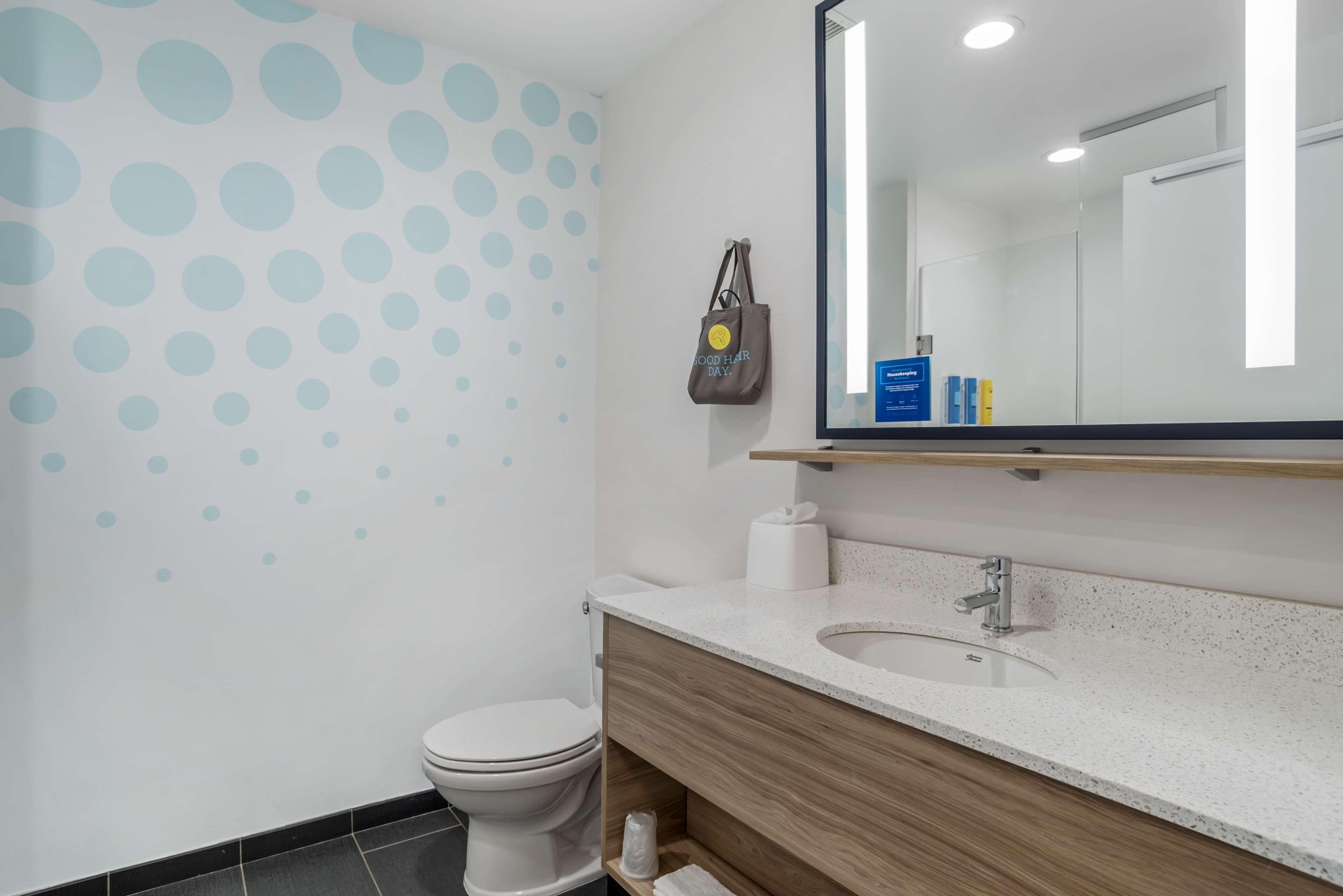 Une salle de bain moderne avec des toilettes, un lavabo et un miroir.