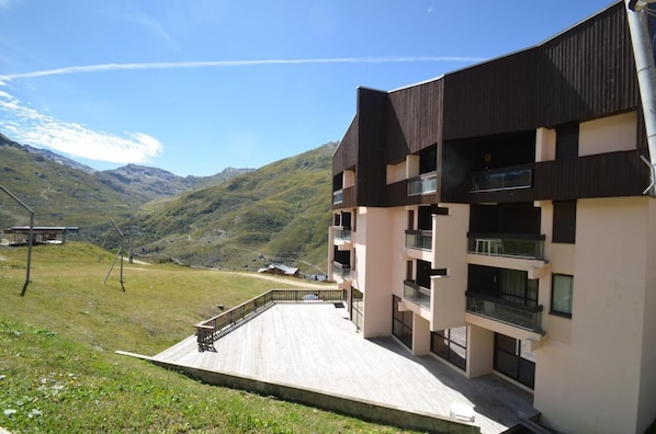Enjoy panoramic views of rolling hills from the building's upper floors, featuring balconies and a spacious deck.