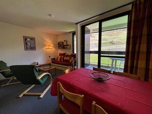 Enjoy a meal in the dining area with a view of the surrounding grassy area.