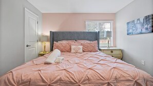 A bedroom with a bed, a nightstand, a lamp, a door, and a window with blinds. - Make your own Escape to Disney in this fantastic pool townhouse! (Davenport)