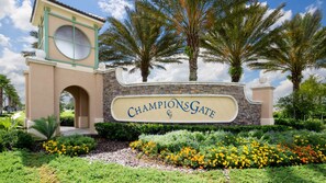 ChampionsGate's elegant entrance welcomes guests with a beautiful stone facade and lush gardens.