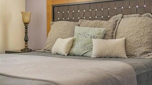 Restful retreat with a tufted headboard and cozy pillows.