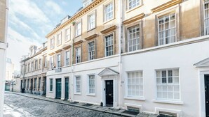 A row of traditional buildings with uniform facades and evenly spaced windows, typical of a historic urban area.