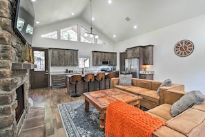Relax in a spacious living area with a fireplace, sofa, and chairs, perfect for unwinding and socializing.