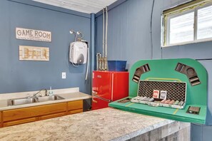 A kitchen with a sink, a refrigerator, and a green appliance with a display. - 3BR West Seneca Apartment Sleeps 9 w/ Game Room (West Seneca)