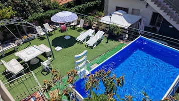 Seasonal outdoor pool, pool umbrellas, pool loungers
