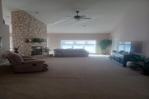 Relax in this cozy living space with a fireplace, flat-screen TV, and comfortable seating.