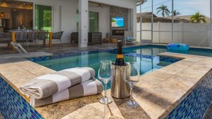 An indoor swimming pool with a bottle of champagne, two glasses, and towels. - Serenity retreat * the ultimate luxury getaway (Naples)