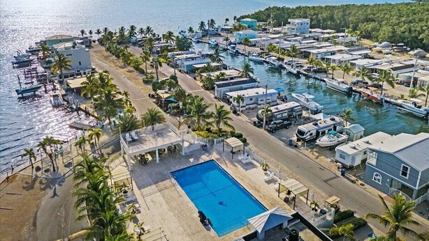 A coastal resort with a swimming pool, marina, and beachfront accommodations. - Key Largo home with new hot tub! (Key Largo)