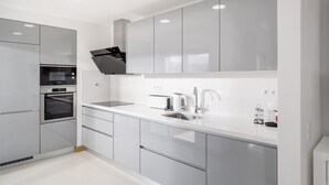 A modern kitchen with stainless steel appliances, white cabinetry, and a sleek countertop. - Lagos Town Centre Apartment (Lagos)