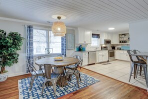 Enjoy cooking in this well-equipped kitchen with a central island, oven, and modern range hood.
