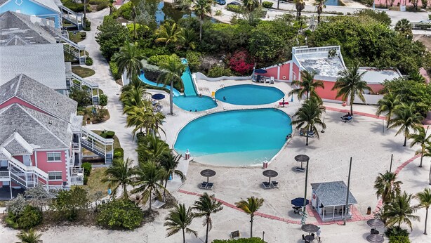 A resort with multiple swimming pools, a beach area, and a variety of buildings. - Convenient Stay in the Heart of Sandyport Olde Towne (Nassau)