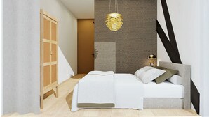 A bedroom with a bed, a hanging light fixture, a nightstand, and a wardrobe. - Residence d' Ouwe Kercke (Terneuzen)