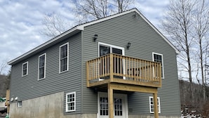 A two-story house with a balcony, a front door, and multiple windows. - Riverview home (Pittsburg)