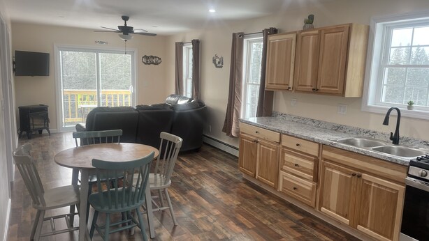A kitchen with wooden cabinets, a granite countertop, and a built-in oven. - Riverview home (Pittsburg)