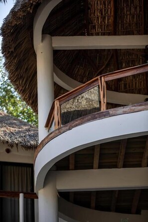 Enjoy the tranquil atmosphere from the curved balcony with a view.
